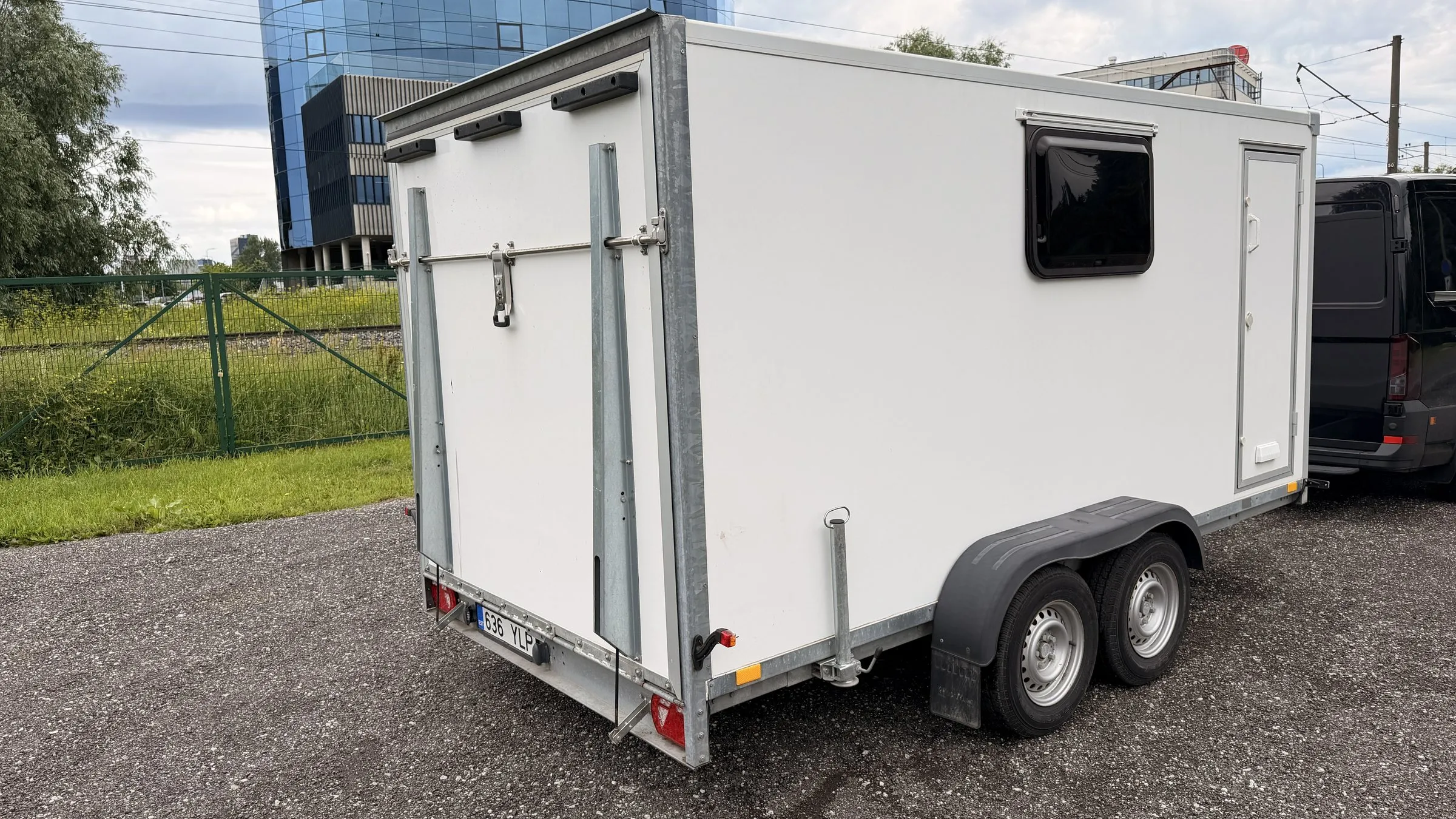 Rear view of the closed box trailer with the ramp closed