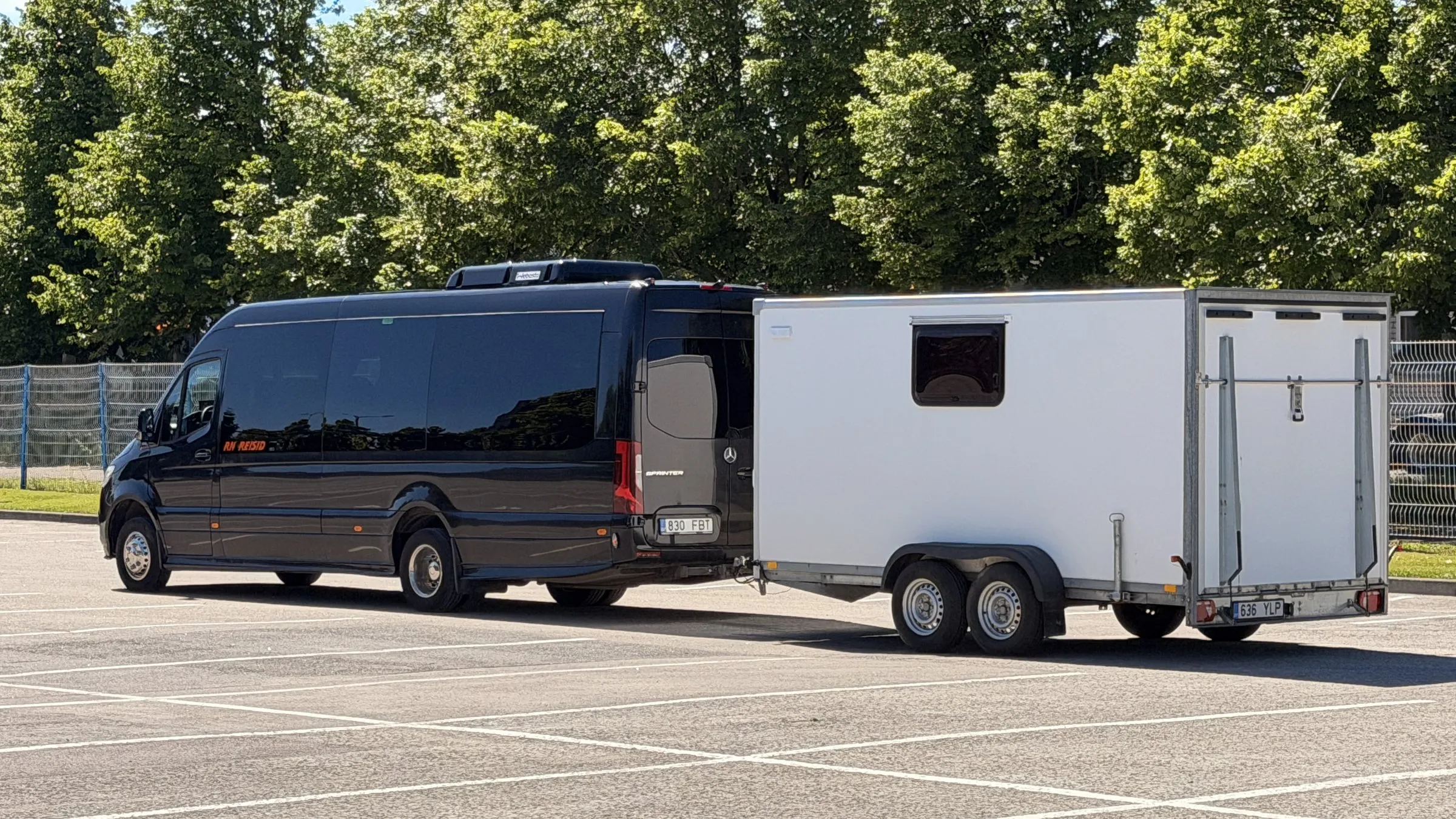 MAN TGE luggage van hitched to the closed box trailer